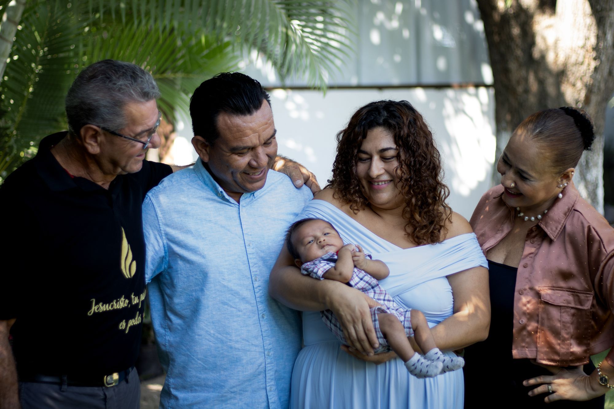 Three generations of a family welcoming a newborn baby